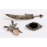 Silver brooches, to include Middle Eastern dagger and scabbard, fairy, brooch with scroll border,