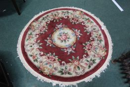 Circular Chinese carpet, the wine red ground with foliate decoration, 130cm diameter