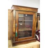 Edwardian mahogany display cabinet, the scroll inlaid pediment above a single glazed door, on a