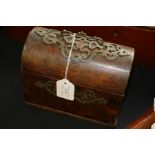 Victorian walnut veneered casket, the dome top with scrolled brass handle above a scroll decorated