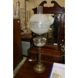 Edwardian oil lamp, the frosted etched globe above a clear glass reservoir and reeded stem, 70cm