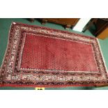 Persian Saraband carpet, the red ground with patterned centre and multiple borders, 215cm x 130cm