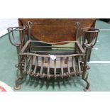 Steel fire basket, with two sconces to the front rail, the basket with twist decoration, raised on