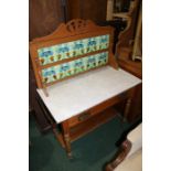 Art Nouveau washstand, the tiled splash-back with foliate design above a marble top and frieze