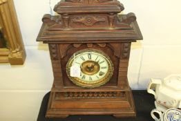 Ansonia American mantel clock, the shaped pediment above an ivorine dial with Roman numerals, on a
