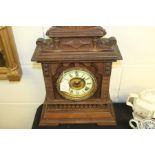 Ansonia American mantel clock, the shaped pediment above an ivorine dial with Roman numerals, on a
