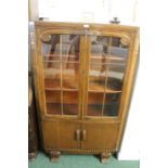 Oak bookcase, with two glazed doors above two cupboard doors, flanked by reeded foliate carved