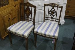 Pair of Edwardian bedroom chairs, with harebell swag inlaid cresting rails, foliate inlaid diamond