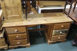 Pine kneehole desk/sideboard, with a rectangular top above five drawers, 145cm wide