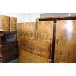 Suite of walnut veneered bedroom furniture, consisting of two bow front wardrobes, dressing table,