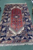 Middle Eastern Carpet, the red ground with multiple borders and tasselled ends,