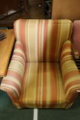 Arm chair upholstered in a striped material, together with a Parker Knoll armchair, with sweeping