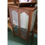 mahogany display cabinet, with two glazed doors revealing two interior shelves, on square tapering