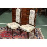 Pair of Victorian walnut bedroom chairs, with pierced scroll carved cresting rails, upholstered