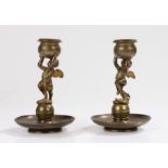 Pair of 19th Century candlesticks, with a pair of putto holding the star decorated sconces above