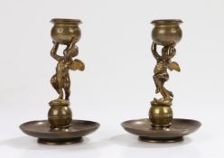 Pair of 19th Century candlesticks, with a pair of putto holding the star decorated sconces above