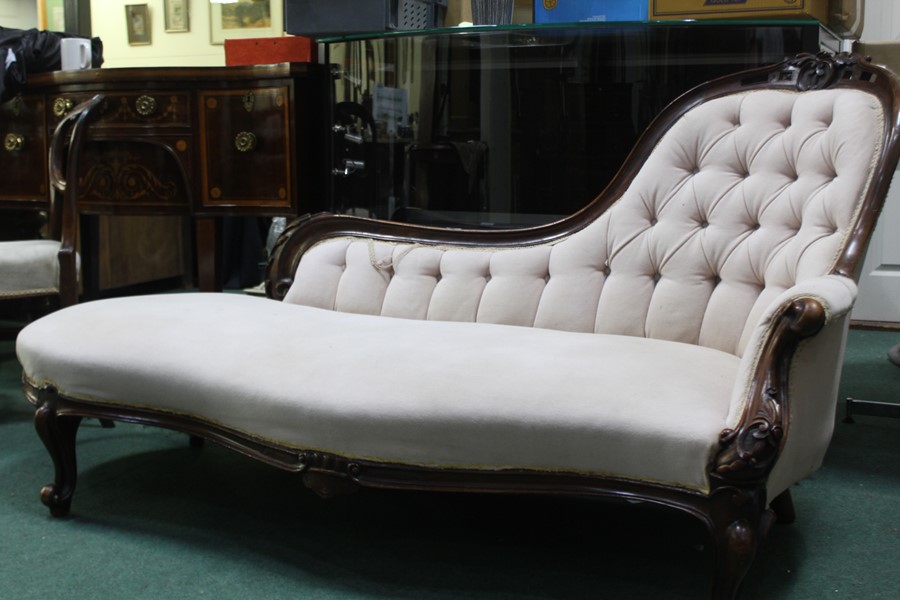 Victorian chaise longue, with button back upholstery, raised on scrolled legs