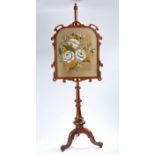 Victorian mahogany fire screen, with a pole above the three cabriole legs, the screen in wool and