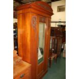 Art Nouveau style wardrobe with central bevelled mirror door flanked by foliate carvings, 106cm
