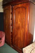 Victorian mahogany wardrobe, of tall proportions, the concave cornice above a pair of double doors