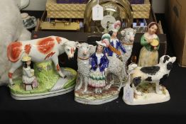 Staffordshire figures, to include cow and milkmaid, spaniel, figures with sheep, lady with bowl (5)