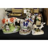 Staffordshire figures, to include cow and milkmaid, spaniel, figures with sheep, lady with bowl (5)