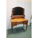 Edwardian mahogany satinwood and boxwood strung dressing table, the arched bevelled mirror above a