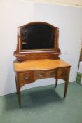 Edwardian mahogany satinwood and boxwood strung dressing table, the arched bevelled mirror above a