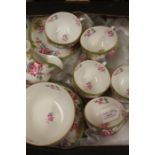 Royal Doulton part tea service decorated with floral sprays, consisting of nine teacups and saucers,