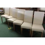 Set of six dining chairs, with cream leatherette upholstered high backs and seats, on square