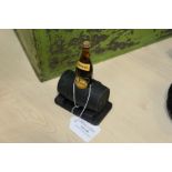 Guinness desk ornament, formed from a miniature bottle housed in a barrel stand, 8cm x 12.5cm
