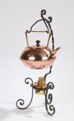 W.A.S. Benson style tea kettle and stand, the copper kettle with angular handle, on a scrolled