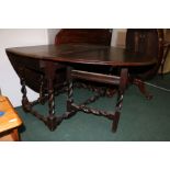 18th Century and later oak drop leaf table, with D shaped leaves and frieze drawer, on barley-