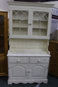White painted pine dresser, the top with two arched glazed cupboards above a base with two frieze