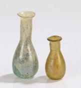 Two Roman 3rd Century bottles, with wide rims and bulbous bodies, 45mm and 70mm high, (2)