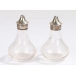 Pair of George V silver mounted clear glass salt and pepper pots, Birmingham 1910, makers mark