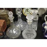 Four cut glass decanters, to include a ships decanter, all with stoppers (4)