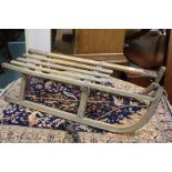 Wooden sledge with slatted seat and metal runners