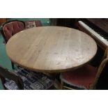 Pine circular dining table on a turned stem and quadruple legs, 106cm diameter