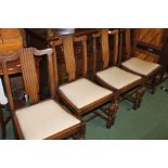 Set of four oak dining chairs, with reeded splat backs, over-stuffed drop-in seats, on bulbous