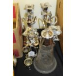 Pair of plated two branch candelabra, plate mounted claret jug, three plated salts (qty)
