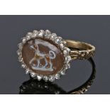 George III agate and diamond ring, the carved agate with a dog and a diamond surround. Ring size K.