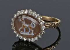 George III agate and diamond ring, the carved agate with a dog and a diamond surround. Ring size K.