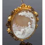 19th Century cameo brooch, the shell cameo carved with lady by a river and town in the distance,