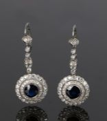 Pair of sapphire and diamond set earrings, the drops with diamond beams and circular sapphire and