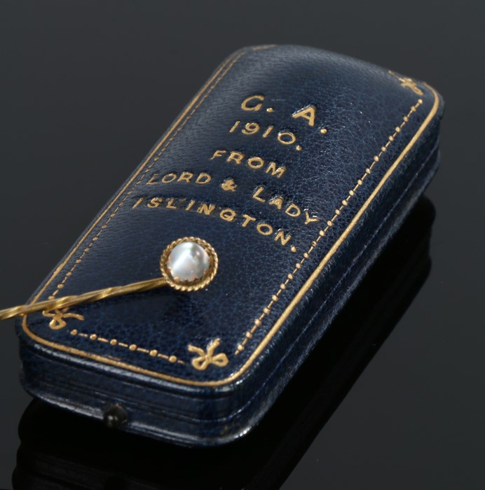 Gold and moonstone stick pin, housed in an embossed presentation box "G.A. 1910 from Lord and Lady