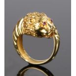 18 carat gold ring, with a ruby set lion head design and a tapering lion tail forming the shank,