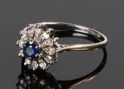 18 carat white gold sapphire and diamond set ring, forming a flower head with central sapphire, ring