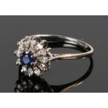 18 carat white gold sapphire and diamond set ring, forming a flower head with central sapphire, ring