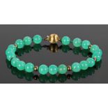 14 carat gold and jadeite braclet, with a row of jadeite stones with a gold ball end, 19cm long